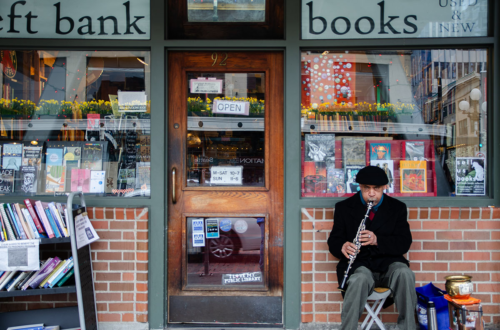 Musician in front of a bookstore