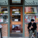 Musician in front of a bookstore
