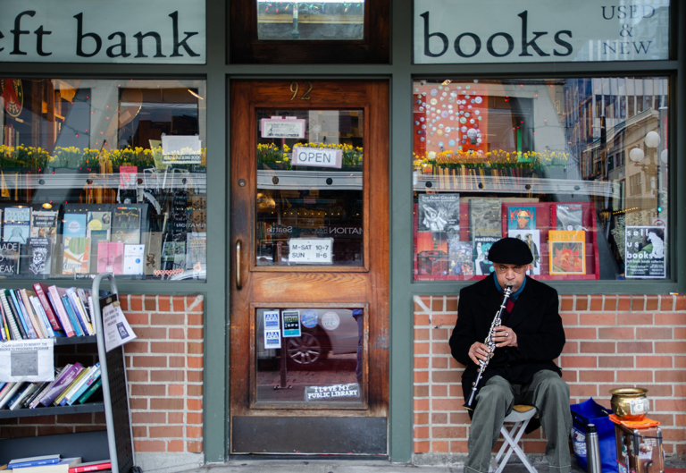 Musician in front of a bookstore